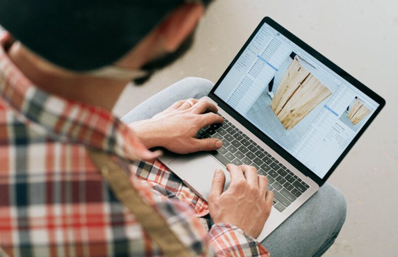Person Using Macbook Air on Lap